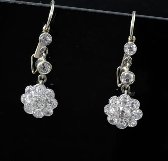 A pair of white gold and diamond flower head cluster drop earrings, 23mm.